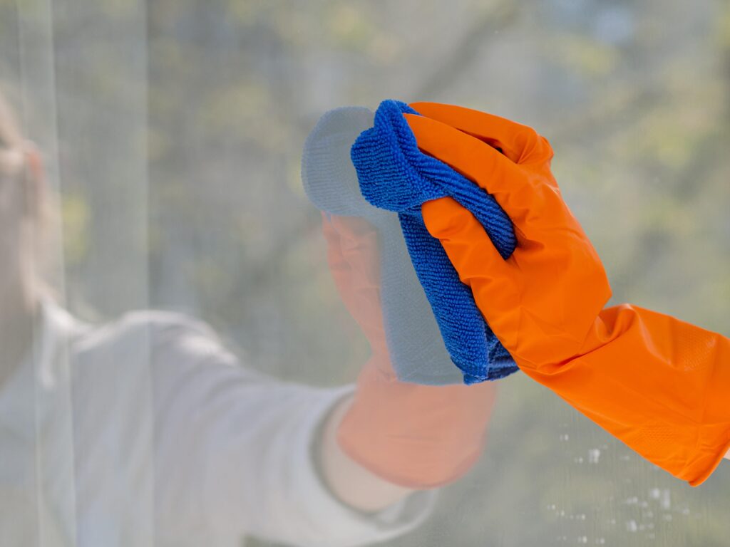 close-up-cleaning-window-with-cloth-min